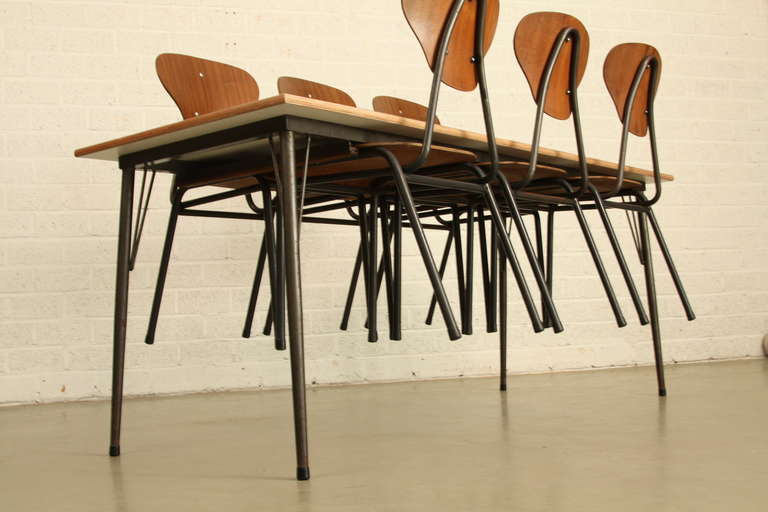 Industrial Danish dinerset. The top of the table is new and has a grey colour paint on multiplex wood. The table frame has the possibility to hang up the chairs. easy to clean the floor. And nice look. The table leggs are conic. the chairs are of