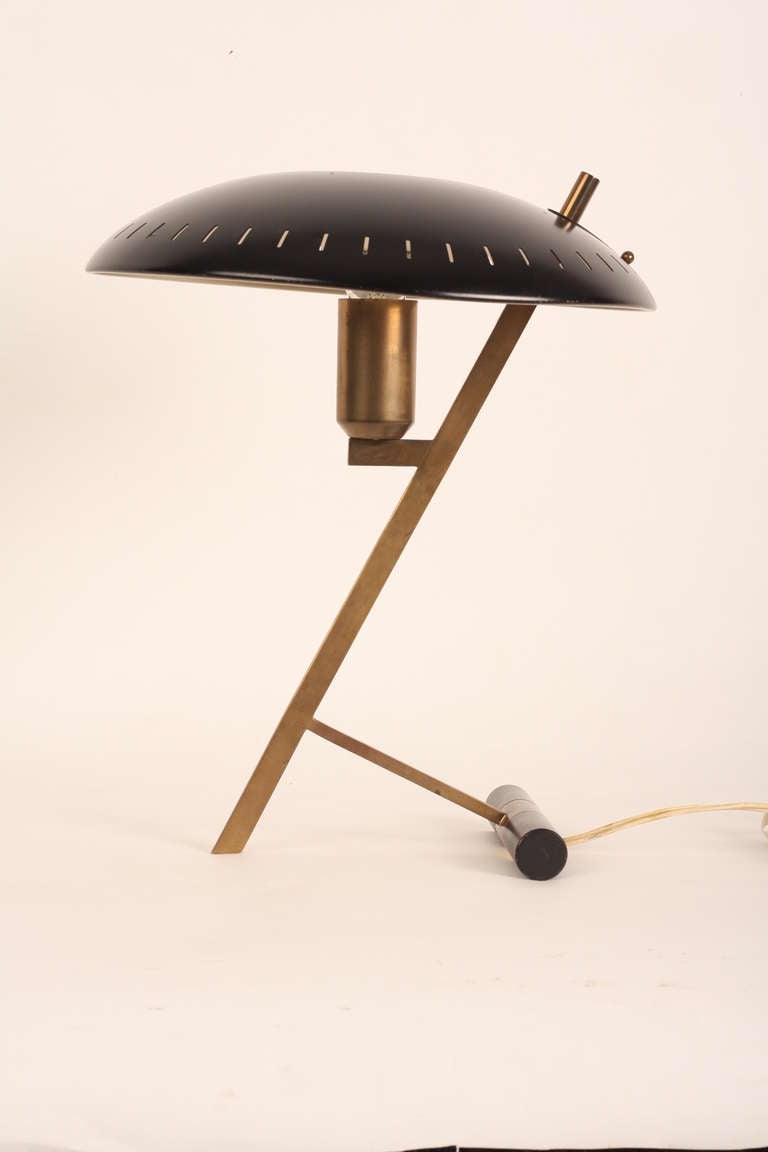 Louis Kalff designed for Dutch company Philips this lamp in 1969. The base is of copper and the hat is of black painted metal. There is a hole in the hat and you can use a mirror lamp for the best effect.