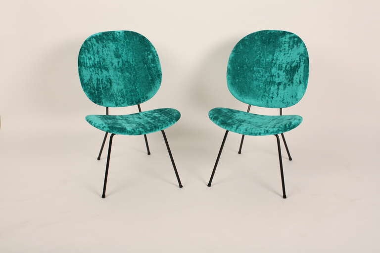 A set of two Kembo chairs from Holland. The chairs are reupholstered with a very happy looking fabric. 