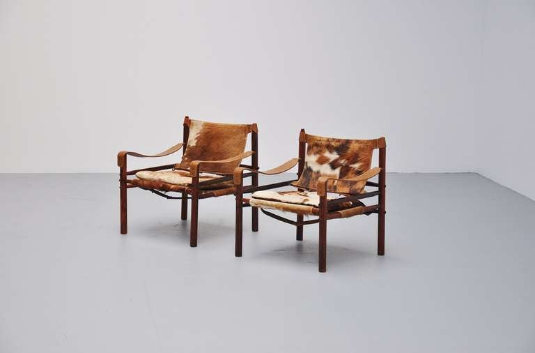 Very rare chairs from the Safari series by Norell, great to match with the Safari coffee tables. These have solid rosewood frames and very nice cow skin seats. The chairs have some wear due to age to the wood and the seats have some professional