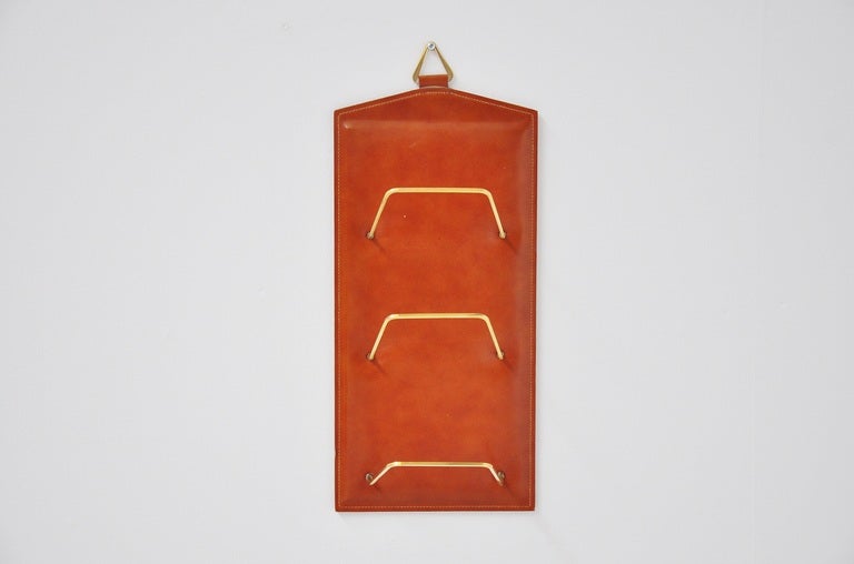 Very nice wall hanging magazine rack, attributed to Jacques Adnet for Hermes 1960. This was made of high quality stitcked leather and has nice grass details. Very easy to hang and highly decorative.