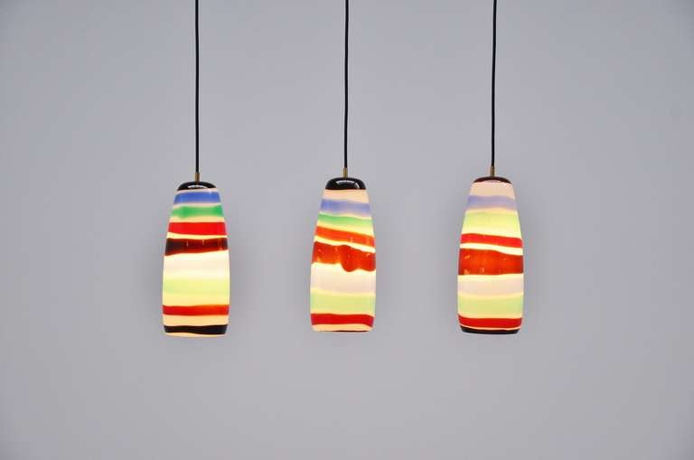 Fantastic set of 3 glass pendant lamps designed by Massimo Vignelli for Venini, Italy 1954. These lights are called Sigaro and were made of multi color blown glass. These lamps give fantastic light when lit and are an amazing set of 3, super hard to