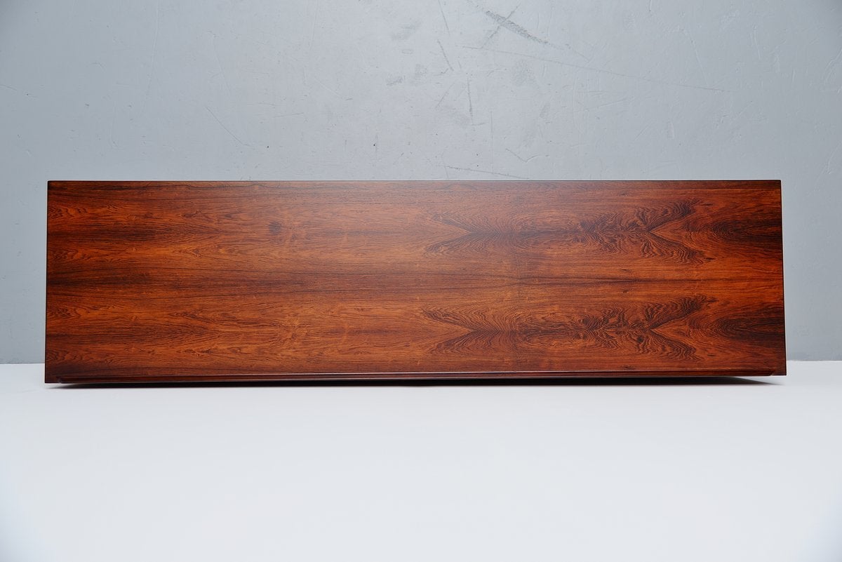 Very nicely refined highboard designed by Arne Vodder for Sibast mobler, Denmark 1958. This nice small highboard has 7 drawers on the left and tambour doors on the right. The rosewood has an amazing grain and makes this a special and unique piece in