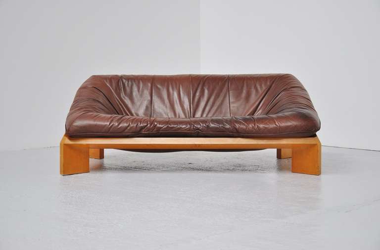 Fantastic lounge sofa by Gerard van den Berg for Montis, Holland 1970.  This super shaped sofa has a fantastic shape and was made of high quality beech plywood and brown leather.  Great contrast with the wood an leather and super patina from age and