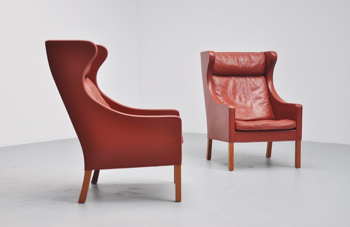Very nice pair of lounge chairs model 2204 designed by Borge Mogensen for Fredericia, Denmark, 1963. These chairs have burgundy leather and solid teak wooden legs. These chairs are made of amazing quality and seat very comfortable. Hard to find in a