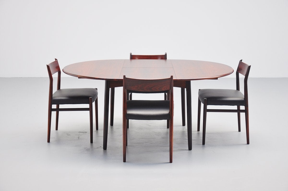 Very nice round or oval rosewood dining table designed by Niels Koefoed for Mobelintarsia, Denmark 1960. This dining table can be extended from a round 120 cm table to an oval 171 cm dining table. Table is marked with the Mobelintarsia sticker