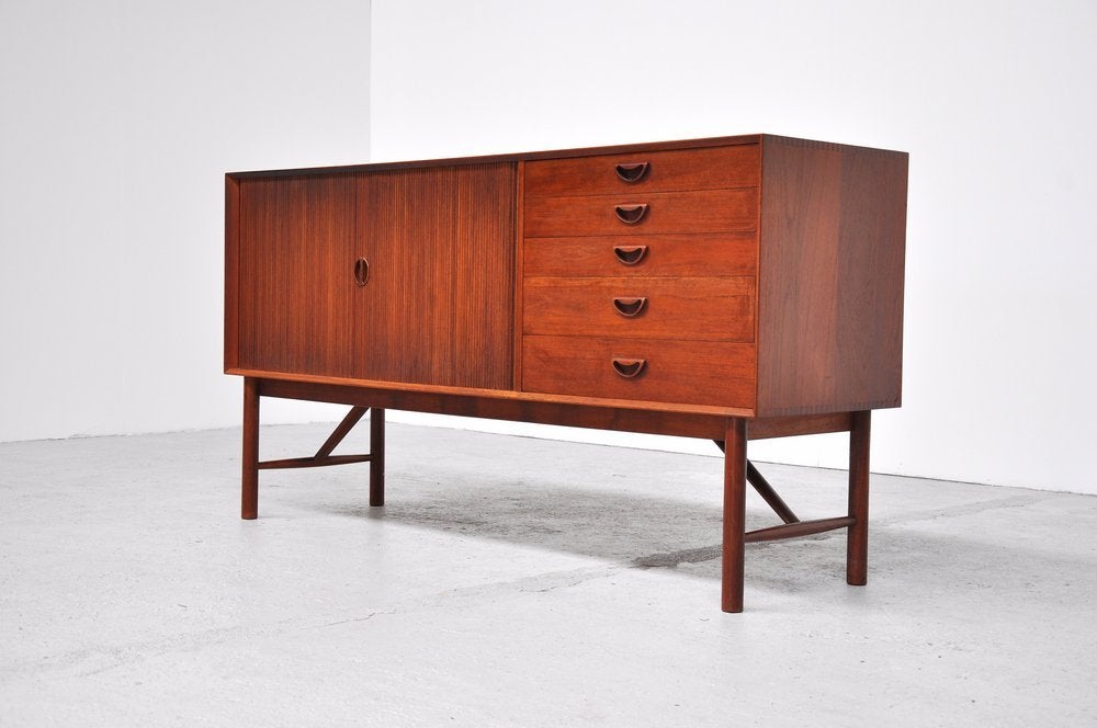 Here for a true diamond to meet the eye. This super quality sideboard designed by Peter Hvidt and Orla Molgaard Nielsen for Soborg, Denmark 1956. This sideboard is model 309 and was made of massive teak. Nice details is the harmonica doors, the