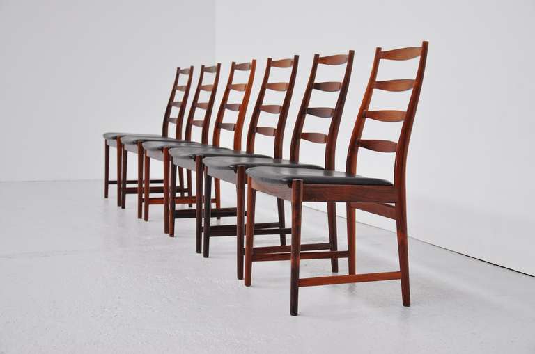 Fantastic set of 6 high back rosewood dining chairs, designer by Arne Vodder for Vamo Sonderborg, Denmark 1960. These amazing chairs have original black leather with fantastic patina. The chairs are in a great condition, all original and are