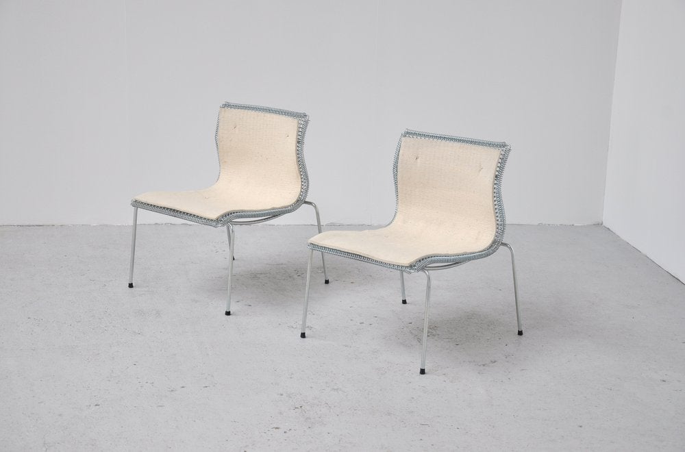 Rare pair of easy chairs designed by Niall O'Flynn for 't Spectrum in 1997. These chairs were in prodcuction for only 4 years. Fantastic shaped chairs, made of galvanised metal. Felt seat for comfort seating. 

Please contact us for affordable