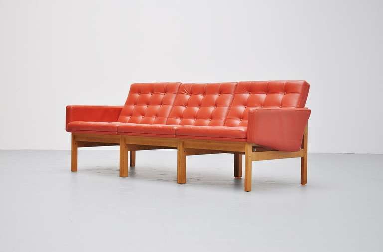 Very nice moduline sofa designed by Ole Gjerløv-Knudsen & Torben Lind for France & Son, Denmark, 1960. This sofa has a solid oak frame and a very nice red tufted leather seat. The sofa comes from first owner who practically never sat on it, so the