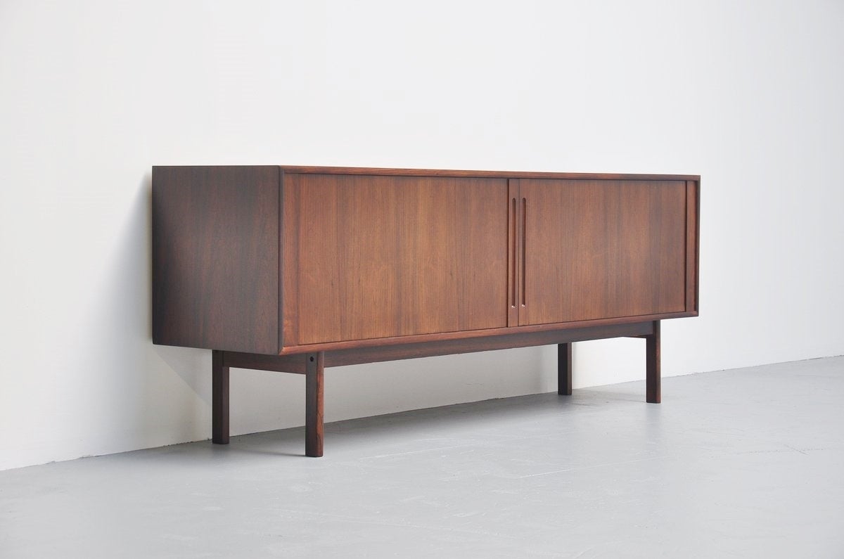 Well crafted rosewood credenza with tambour doors made by Georg Petersens Mobelfabrik, Denmark 1960. This wonderful credenza has 2 tambour doors with plenty of storage space behind it, incl 3 drawers that are adjustable in height if wanted. The