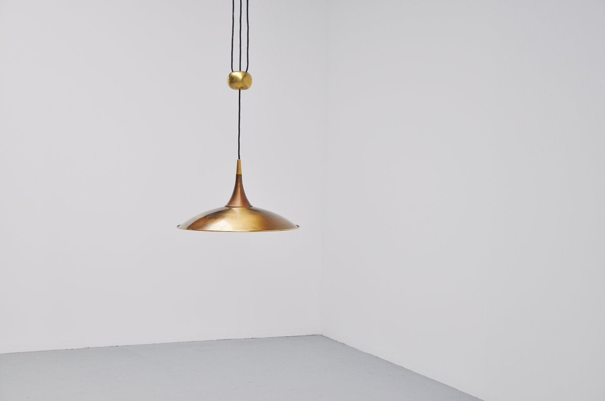 Very nice adjustable ceiling pendant designed by Florian Schulz, Germany 1970. This lamp has a weighted ball on the middle to adjust the height of this. It gives very nice diffused light with the reflector shade and small diffuser underneath. Lamp