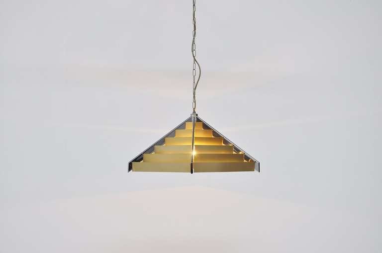 Fantastic pendant lamp designed and manufactured by Geatano Sciolari, Italy 1970. This amazing lamp was made of chrome and brass aluminum strips. This lamp gives amazing light when lit and is in super condition. Marked Sciolari on the inside of the