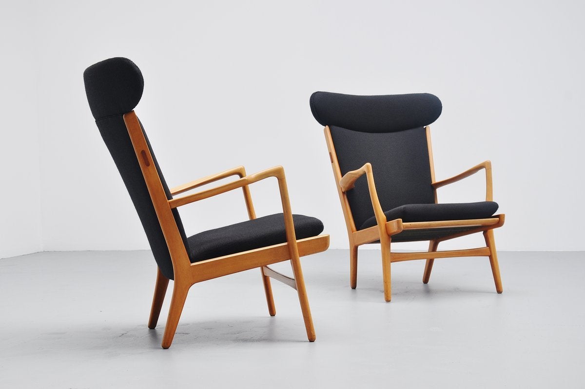 Very nice pair of wingback lounge chairs model AP-15 designed by Hans J. Wegner for AP Stolen, Denmark, 1951. Nice high back lounge chairs for comfortable seating, solid oak frames in excellent condition with black fabric, professionally upholstered