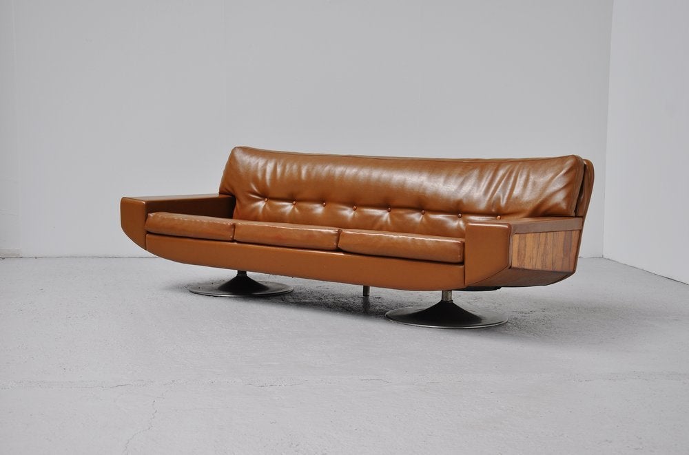 Fantastic shaped Dutch sofa by Topform, who was one of the better furniture makers in Holland during the 60s and 70s. This camel brown colored sofa was made of vynil upholstery and has very nice rosewood sides and aluminium tulip shaped feet. This
