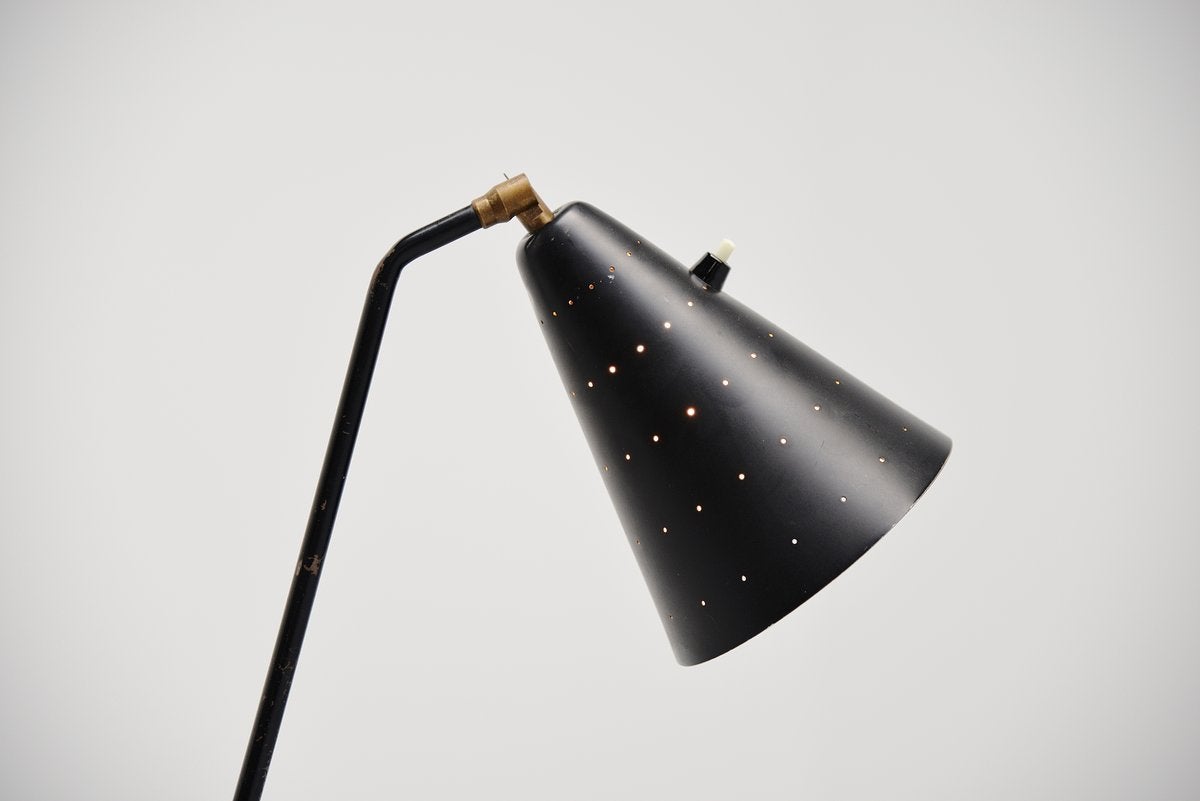 Very nice and subtle floor lamp designed by Svend Aage Holm-Sorensen for Holm Sørensen & Co, Denmark, 1950. This is for a black lacquered version, nice shade with a die cut dot pattern for nice light effect, adjustable shade with brass joint and the