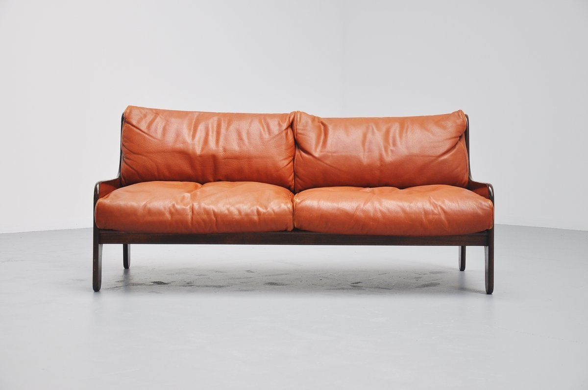 High quality lounge sofa designed by Marco Zanuso for Arflex, Italy, 1964. The frame is made of mahogany plywood and the cushions are covered with high quality cognac leather and have feathers inside. Nicely shaped mahogany plywood frame is a great
