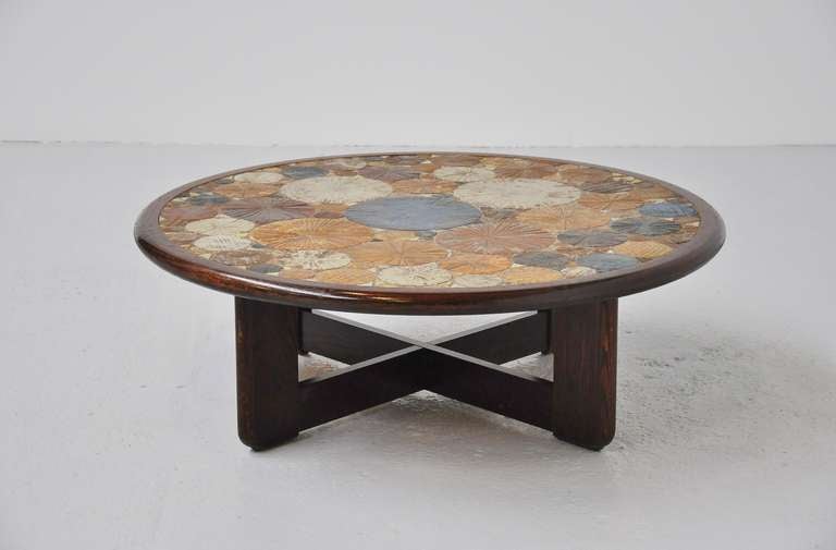 Fantastic coffee table designed by Tue Poulsen for Haslev Møbelsnedkeri A/S, Denmark, 1963. This has multiple colored ceramic art tiles, a small one is signed 'Tue'. The table has a dark stained oak wooden edge and cross feet. Table looks highly
