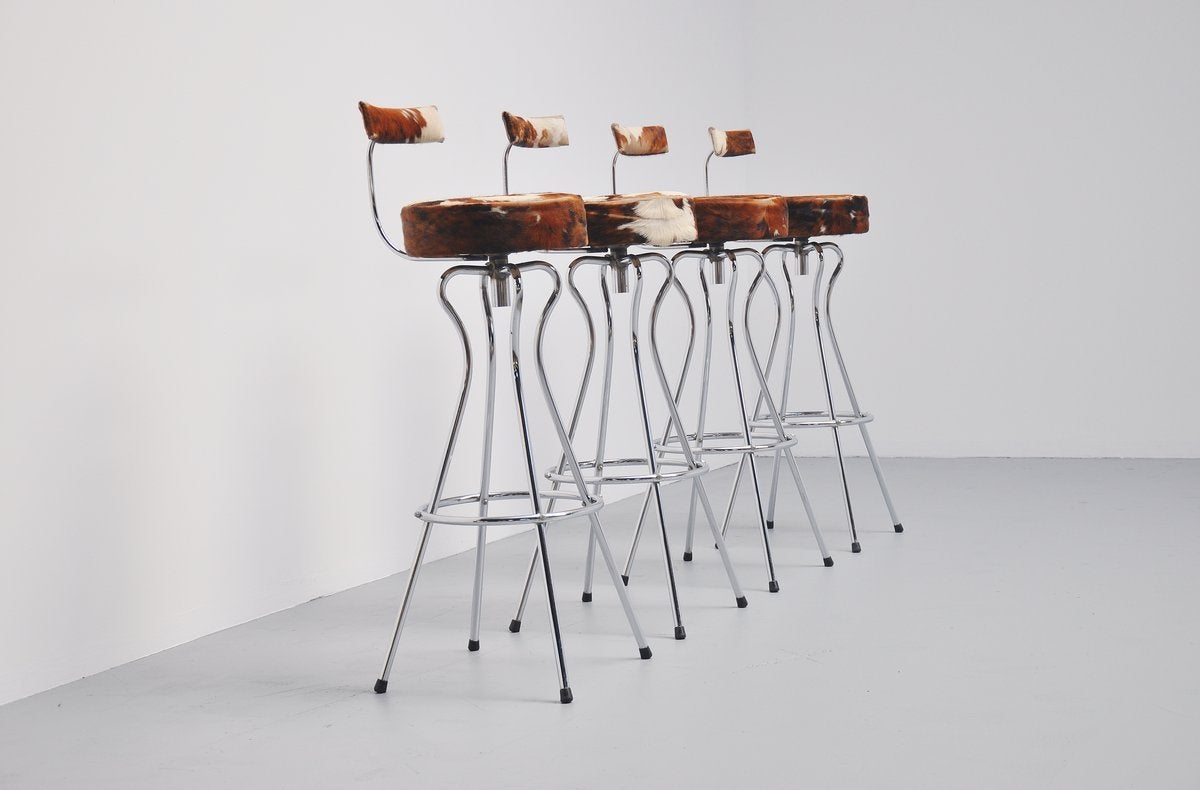 Very nice set of bar stools made by unknown designer in Germany 1965. These stools are very well shaped and have a chrome tubular frame with cow skin seat and back rest. Typical 1960s design and they sit very comfortable too. The seats swivel and