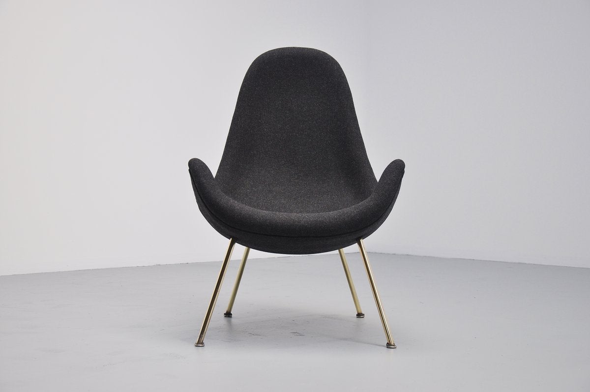 Very nice organic shaped lounge chair attributed to Fritz Neth for Correcta, Germany 1950. This excellent lounge chair has solid brass leggs and we have newly upholstered it with Tonica fabric by Kvadrat. The chair seats very comfortable and looks