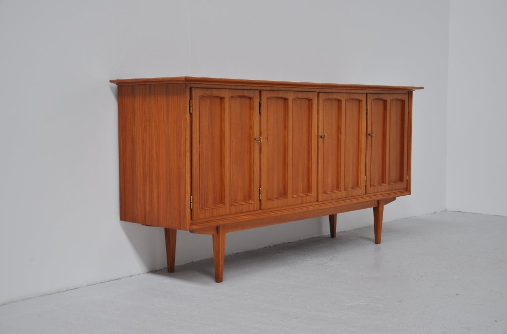 Very nice sideboard with elegant graphic doors from Sweden, 1960. Nice small sideboard in beech with very nice details, the nice grained top veneer is a very nice detail, graphic doors and brass handles and white enterior drawers inside. This