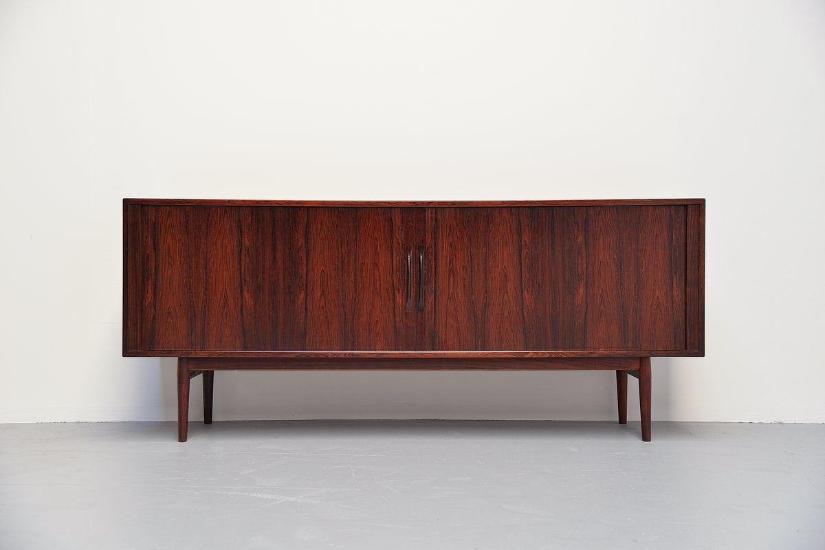 Very nice sideboard model 37 designed by Arne Vodder for Sibast Mobler, Denmark 1960. This nice rosewood sideboard has an amazing grain and still its original lacquer finish. Very nice dark color to the wood. Sideboard has tambour doors and shelves