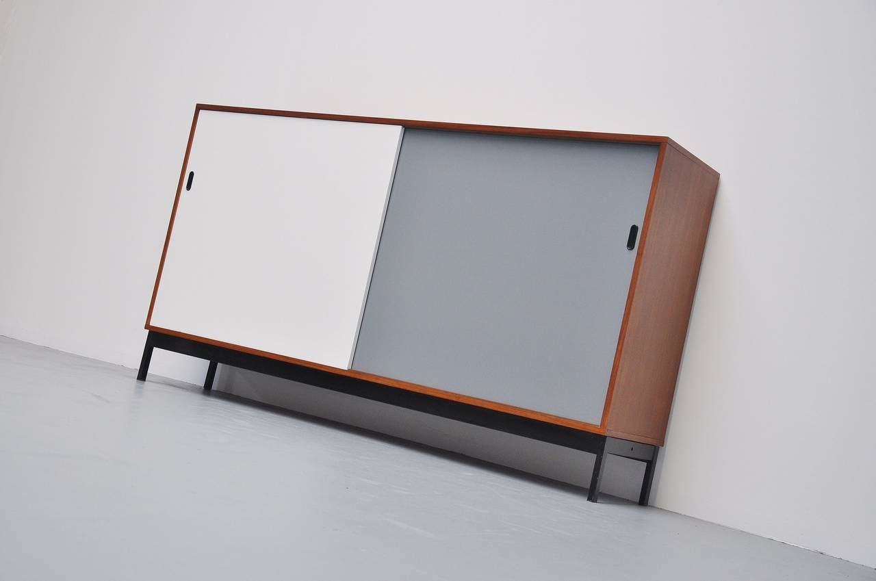 Fantastic large school cabinets in the manner of Florence Knoll, Willy Van Der Meeren and Pastoe. These come from a school and were made in Holland in the 1950s. These large sized credenza's have a teak body with grey and white lacquered doors with