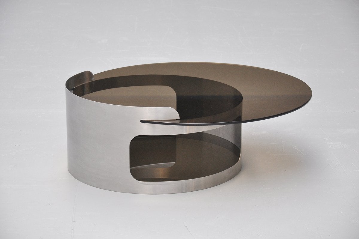 Very nice quality coffee table possible designed by Maria Pergay or Francois Monnet for Kappa, France, 1970. This coffee table base has a brushed steel base supporting two smoked steel glass tops. The table is very well made and made in France or