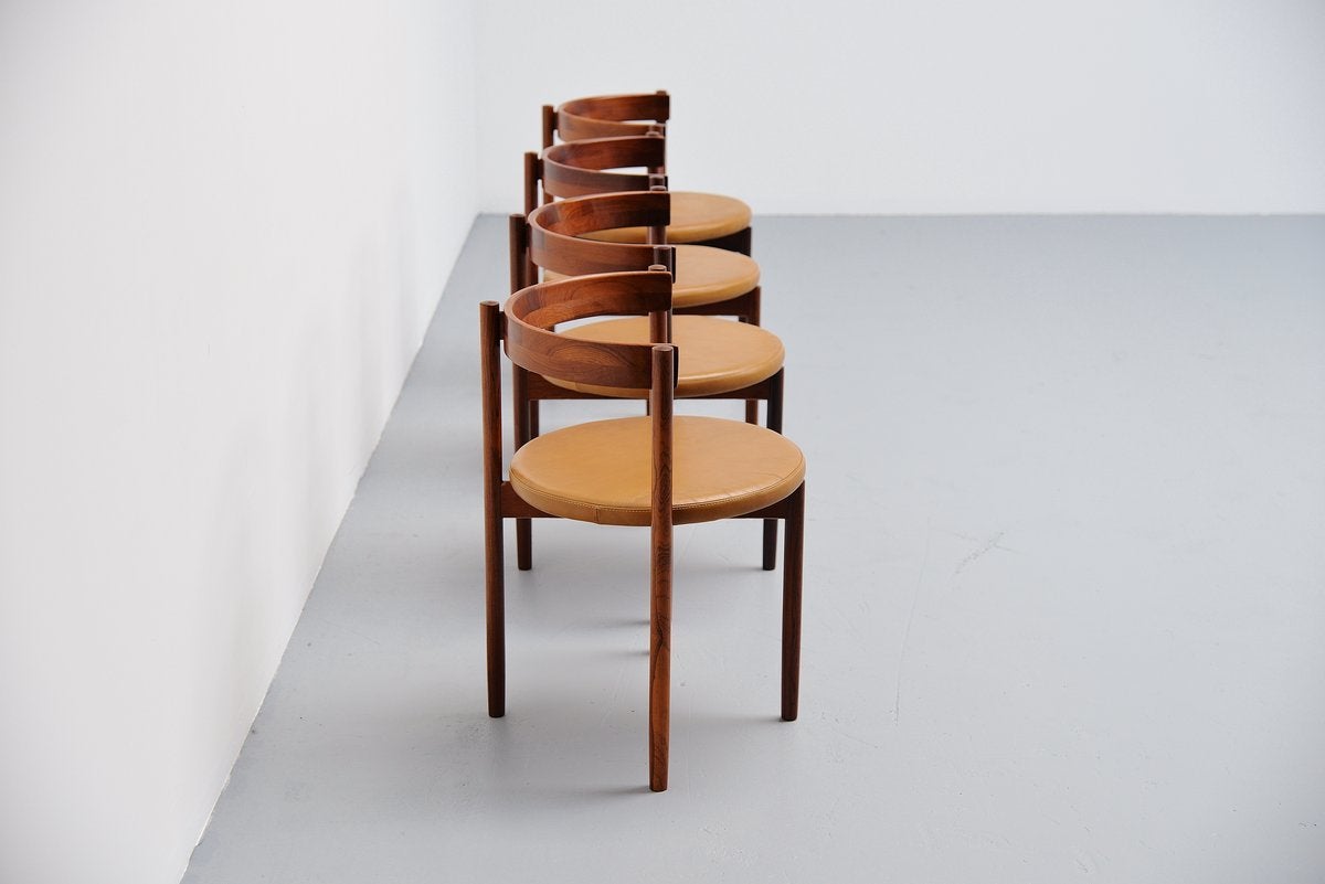 Excellent set of dining chairs in nice and uncommon shape, designed by Hugo Frandsen for Børge M Søndergaard, Denmark, 1964. These chairs have solid rosewood frame and camel leather upholstery. The chairs are still fully original and in excellent
