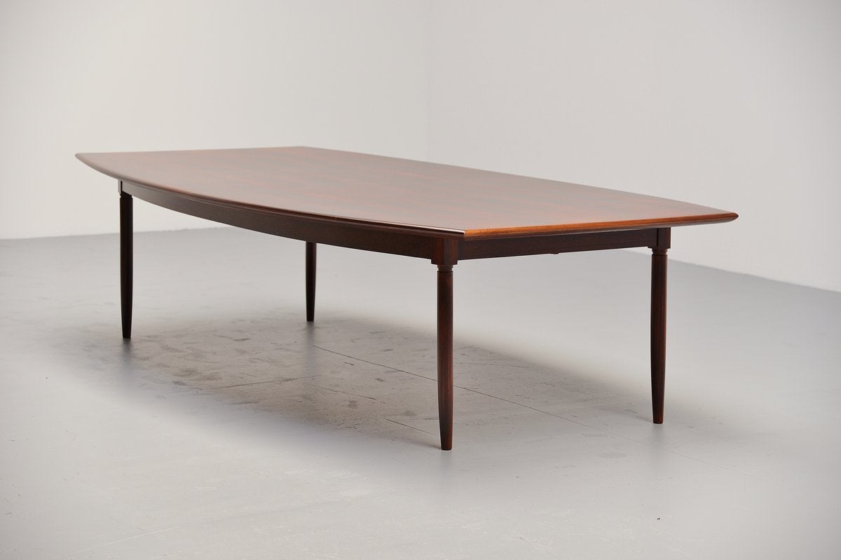 Amazing big conference or dining table made in Denmark, 1960. This nicely shaped and finished table has a beautiful rosewood grain to the top and has solid rosewood legs. The table has an exceptional size and looks very nice with 8/10 chairs on it.