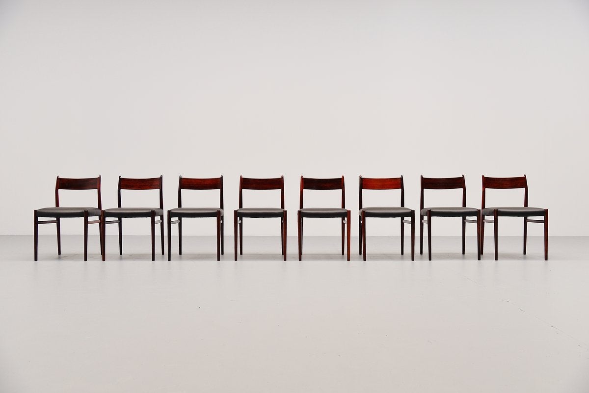 Very nice set of eight dining chairs model 418 designed by Arne Vodder for Sibast Mobler, Denmark 1965. These chairs are made of solid rosewood and are newly upholstered in black Hulshoff leather, the best quality leather available. The chairs are