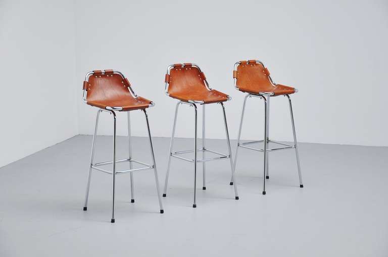 Very nice and wanted pair of 3 bar stools by Charlotte Perriand for Ski resort Les Arcs in 1960. This is for a set of 3 high stools in very good original condition. The stools have chrome tubular frames and high quality thick natural leather seats.
