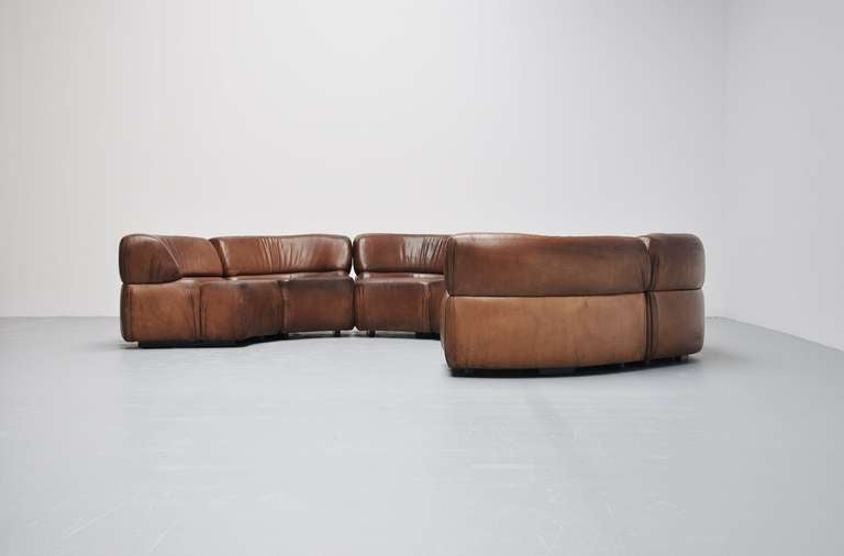 Fantastic modular sofa by De Sede. Very rare model called Cosmos,
medium brown leather with patina to the surface.