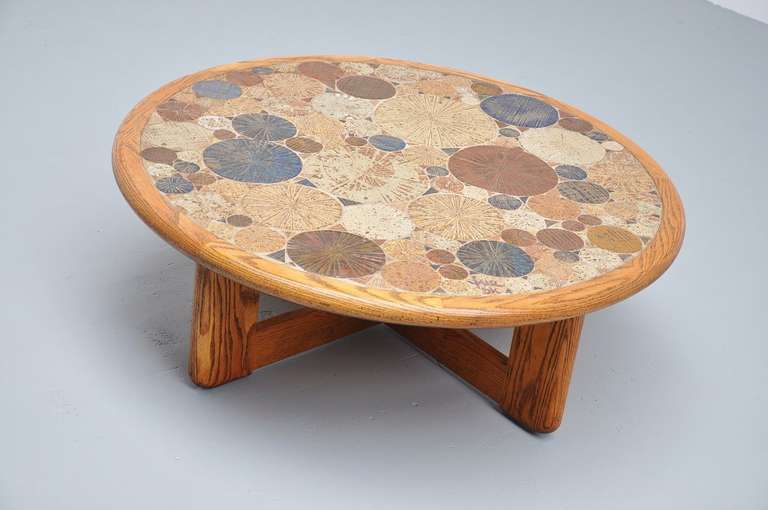 Very nice artwork coffee table designed by Tue Poulsen for Haslev Møbelsnedkeri A/S, Denmark 1963. This table has a solid oak base and edge with numerous ceramic round tiles with a nice motive. Table is marked on 1 ceramic tile: TUE DK. Table is in