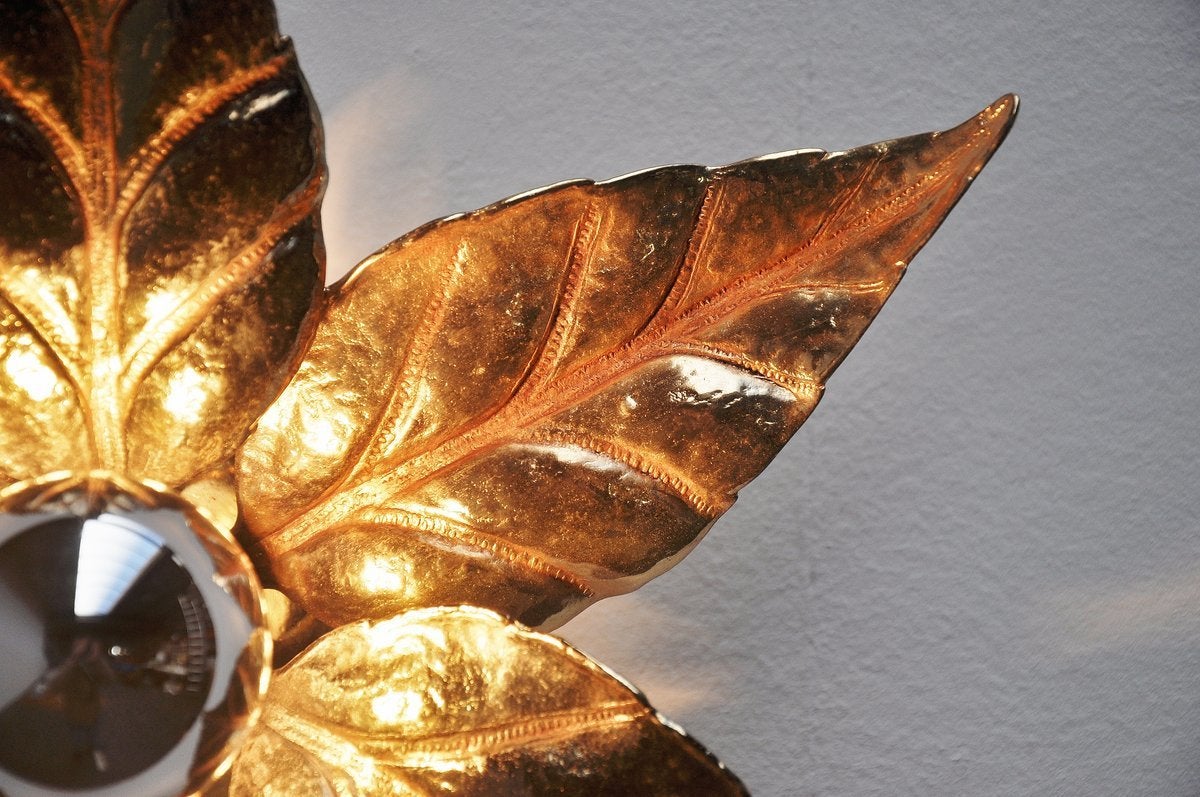 Very nice brass flower sconces attributed to Willy Daro, made in Belgium, 1970. These sconces are made of brass and look like a lifesize flower, very nice sculpted in brass. The lamps give very nice warm light when lit and we have seven available at