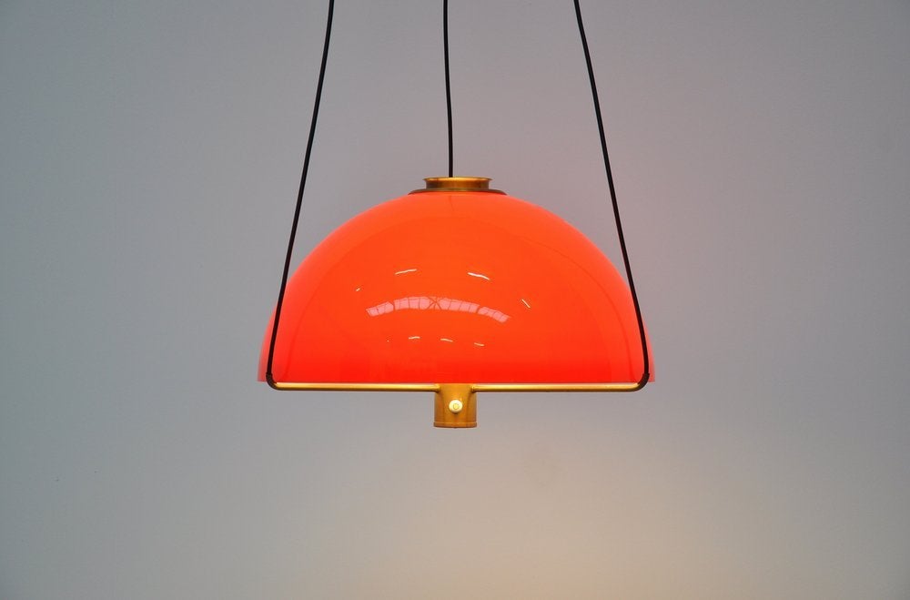 Fantastic ceiling lamp designed by Hans Agne Jakobsson for AB Markaryd, Sweden 1960. This fantastic shaped lamp has a very nice and bright red plastic shade and brass frame and wall plate. This lamp gives fantastic light when lit and probably is one