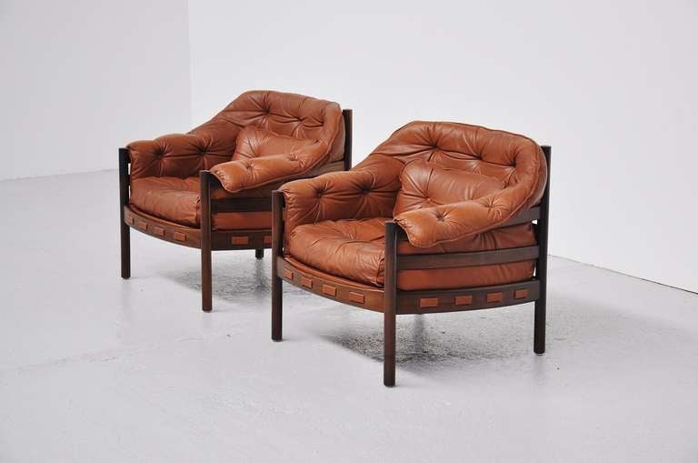 Very nice and comfortable set of club chairs by Arne Norell for Coja, Sweden 1960. Super shaped set with solid teak frames and cognac leather seats. The set has a very nice patina to the leather and is still in very good condition. Comfort seating