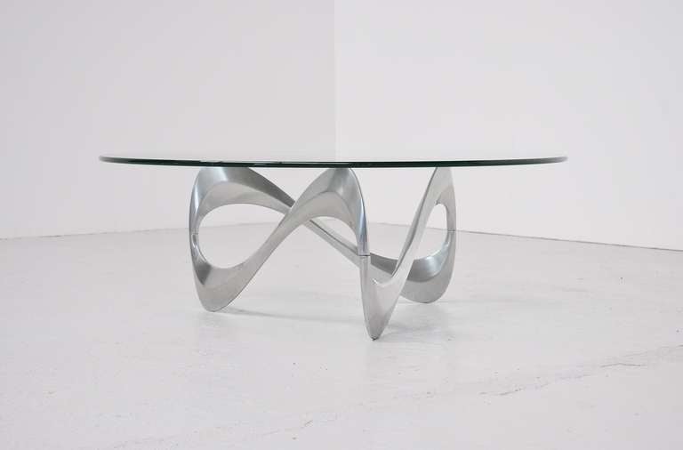 Fantastic shaped coffee table designed by Knut Heserberg for Roland Schmitt, Germany 1965. This table has a solid aluminum foot and thick hardend glass top. The table is in super condition and would look very elegant in any home or interior.
