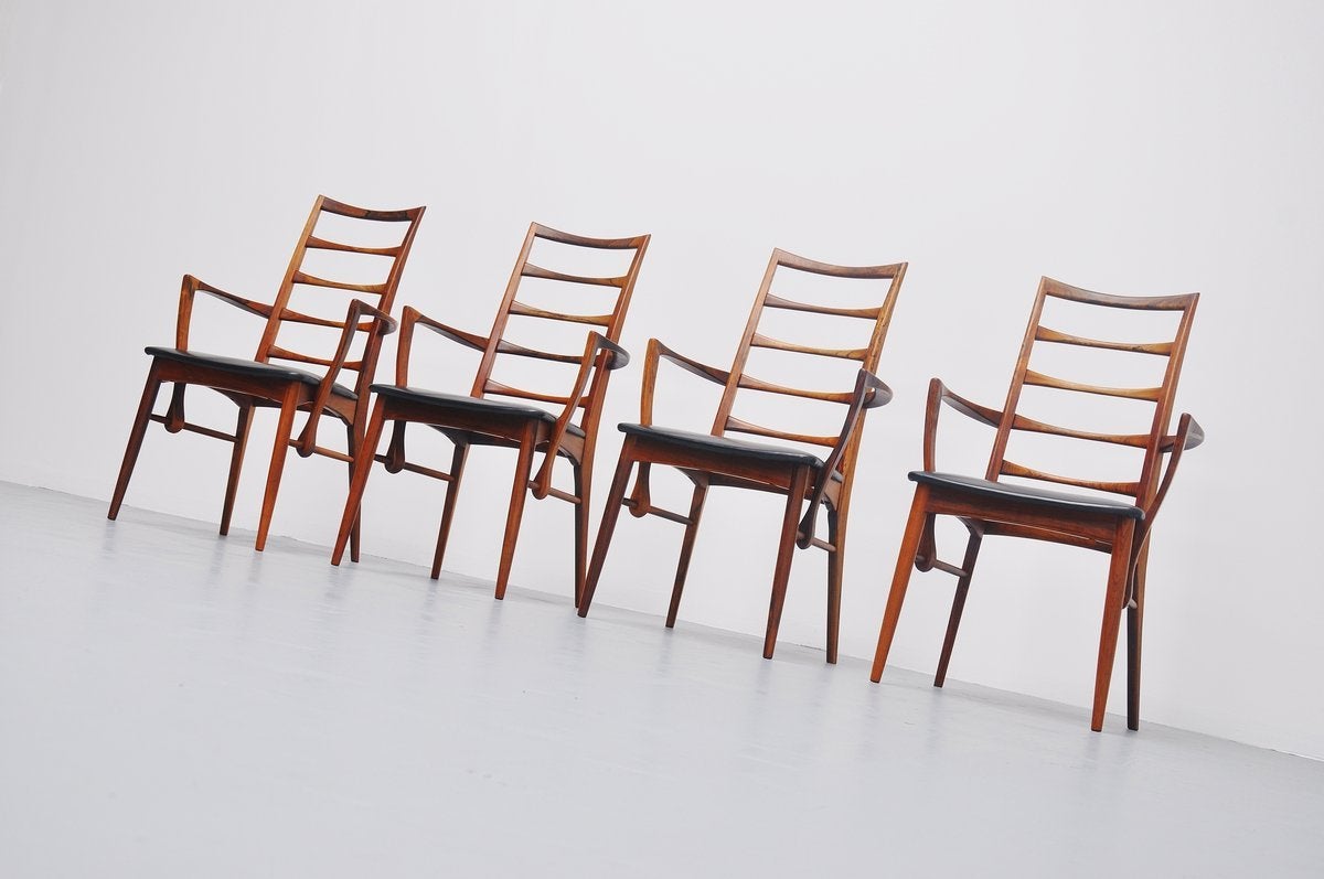 Beautiful set of high back dining chairs model Lis, designed by Niels Koefoed for Koefoeds Møbelfabrik A/S, Denmark, 1961. These chairs are made of solid rosewood with amazing grain to the wood and they have original black vinyl upholstery in