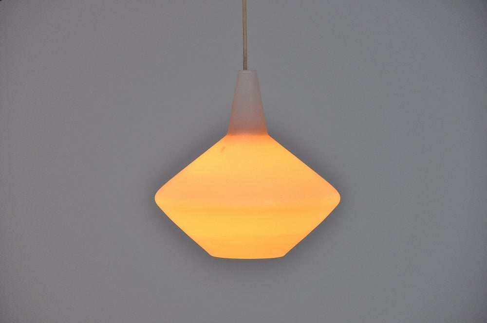 Beautiful teak arc wall lamp designed by Lisa Johansson Pape, Finland 1960. This rare and early wall lamp designed by Lisa Johansson Pape is very hard to find. The combination of teak and frosted glass looks magnificent. The arm doesnt hang regular,