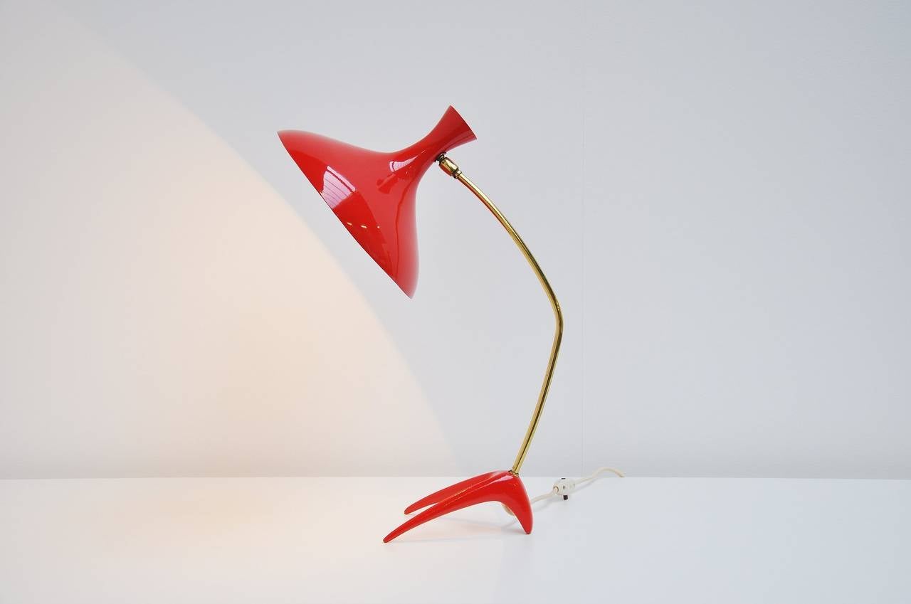 Fantastic dynamic and modernist shaped desk or table lamp made by Cosack, Germany 1950. This amazing shaped lamp has a bright red color and nice brass details. This lamp is made of high quality and we refinished the red parts in the original color.
