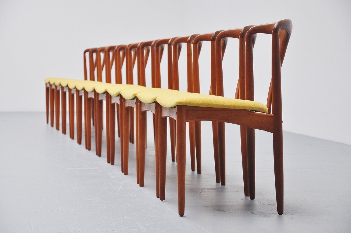 Very nice large set of 12 dining chairs designed by Johannes Andersen for Uldum Mobelfabrik, Denmark, 1960. These chairs are made of solid teak and they are newly upholstered in flora fabric by Kvadrat. The chairs have a comfort seat and look