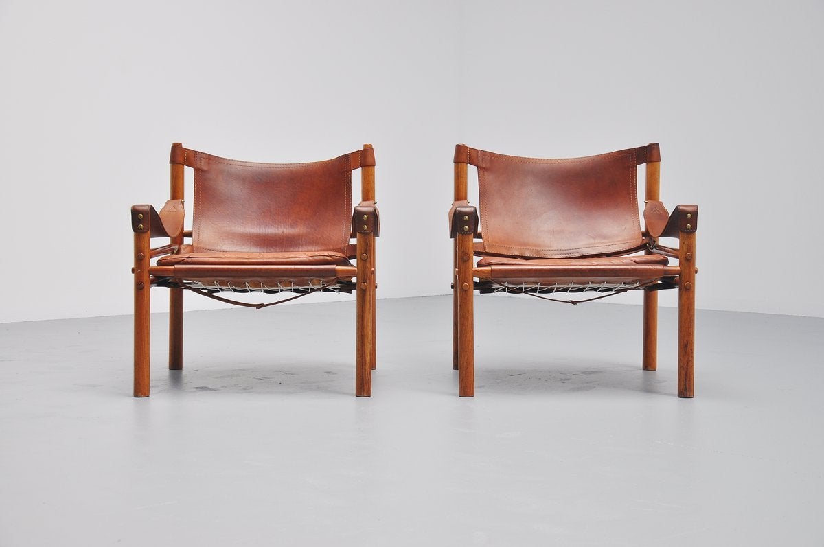 This is for an amazing pair of lounge chairs designed by Arne Norell for Norell Mobler, Sweden 1964. These versions are made of solid rosewood frames and they have a fantastic cognac seat with wonderful patina from age and usage. I have rarely seen