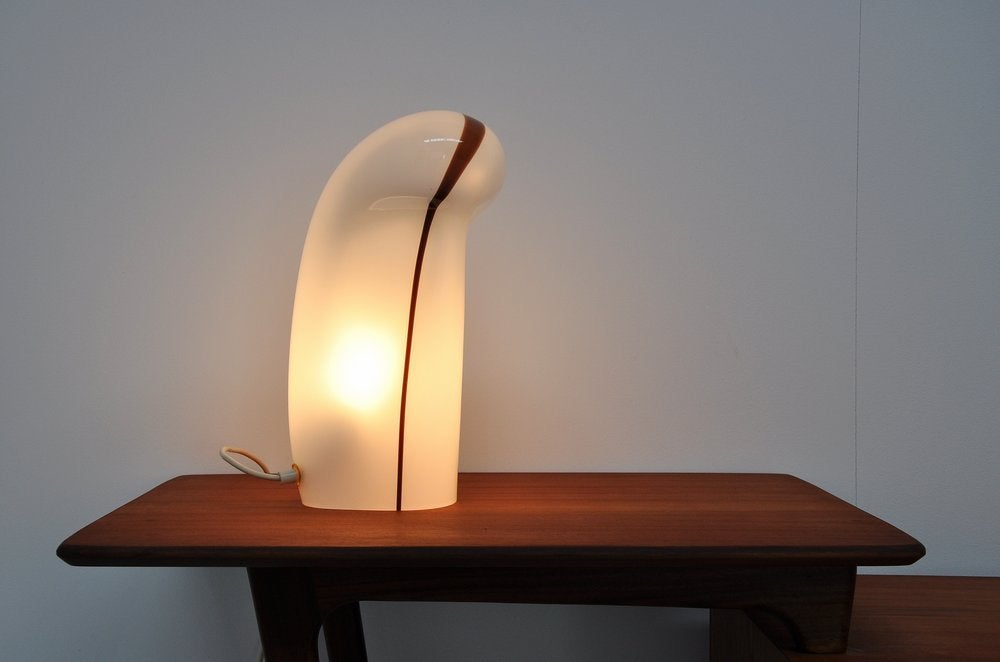 Very nice shaped 'ghost' table lamp designed by Gino Vistosi for Vistosi Murano ca 1960. This cool thick glass table lamp has the shape of a ghost and has a brown stripe crossing it from top to toe. The lamp is in perfect condition and gives very