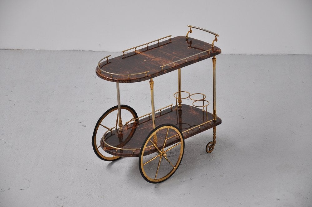 Very nice and decorative tea cart by Aldo Tura for TURA Italy 1950. This goat skin covered tea cart has a brown color with brassed plated metal details. The cart is in good condition, just the wheels have some wear from normal age and usage.