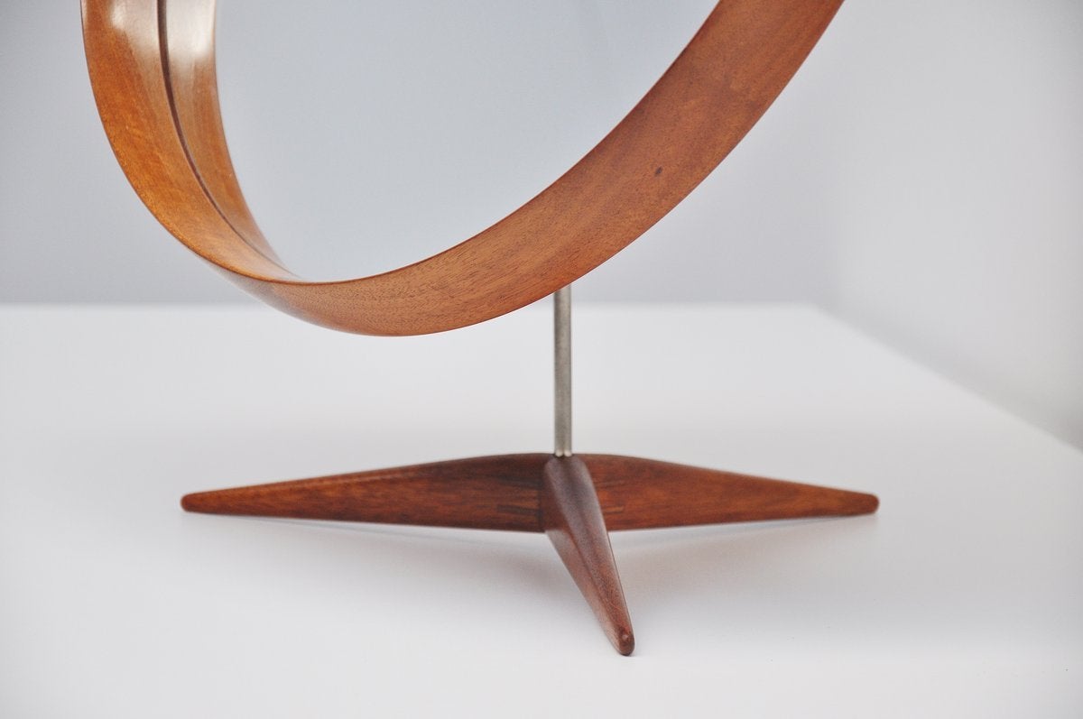 Super shaped teak table mirror designed by Uno and Osten Kristiansson for Luxus, Sweden 1960. This solid teak mirror is very wel crafted with nice dovetail connections in the rim and tripod base. Probably one of the nicest table mirrors ever made.