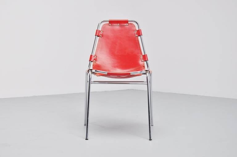 Original side/dining chair by Charlotte Perriand for Ski resort Les Arcs in 1960. It has a chrome tubular frame and high quality thick red leather seat. The leather seat has a little crack which is to be seen on the pictures. Chrome frame is in