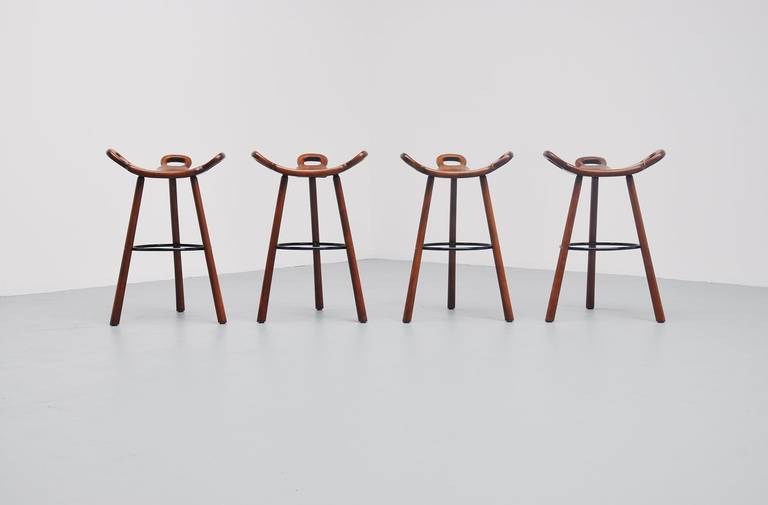 Very nice brutalist bar stools, model Marbella imported from Spain by Confonorm, 1970. Very nice stained oak wooden stools with metal feet supporting ring. Stools are very comfortable for any person and look amazing in any home or interior. We