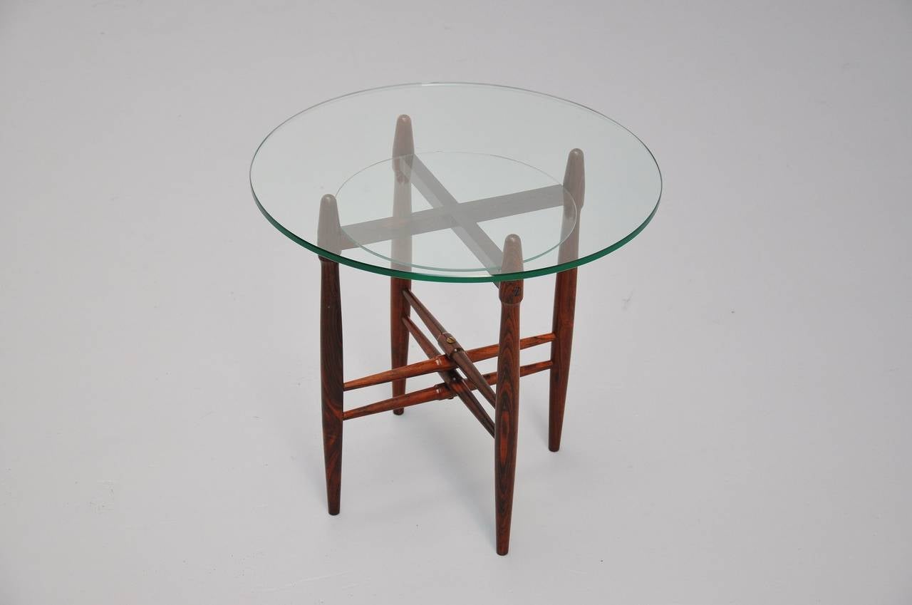 Amazing shaped side table by Poul Hundevad. Super made of solid rosewood and very thick glass top.

Please contact us for affordable global shipping quotes, we ship from $50 for small items up to $500 - $ 1,000 for larger items. We also provide