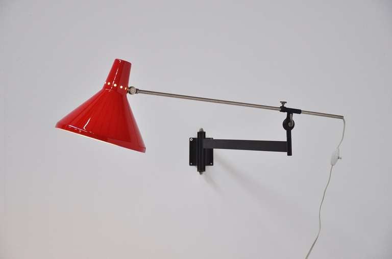 Fantastic wall lamp with fully adjustable arm and bright red shade. Very functional and adjustable in numerous positions.